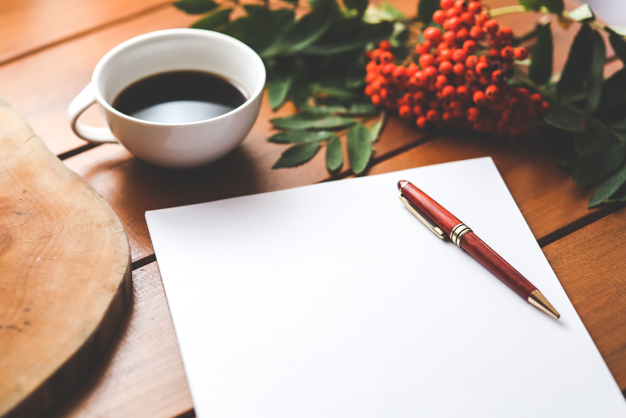 blank-paper-with-pen-and-coffee-cup-on-wood-table-6357